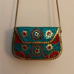 Antik Kraft mosaic crossbody bag with gold tone accents and chain strap